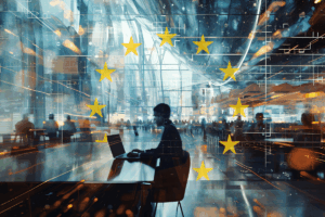 Persona trabajando con ordenador en un entorno digital futurista, sobreimpresionado con la bandera de la Unión Europea. Representación de la psicotecnología, la inteligencia artificial aplicada y los desafíos éticos en el contexto europeo.